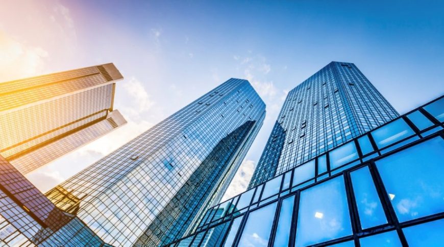 Modern skyscrapers in business district at sunset with lens flare effect